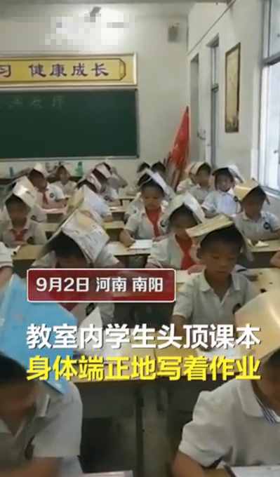 小学生头顶课本写字，网友：还是老师厉害，专治驼背